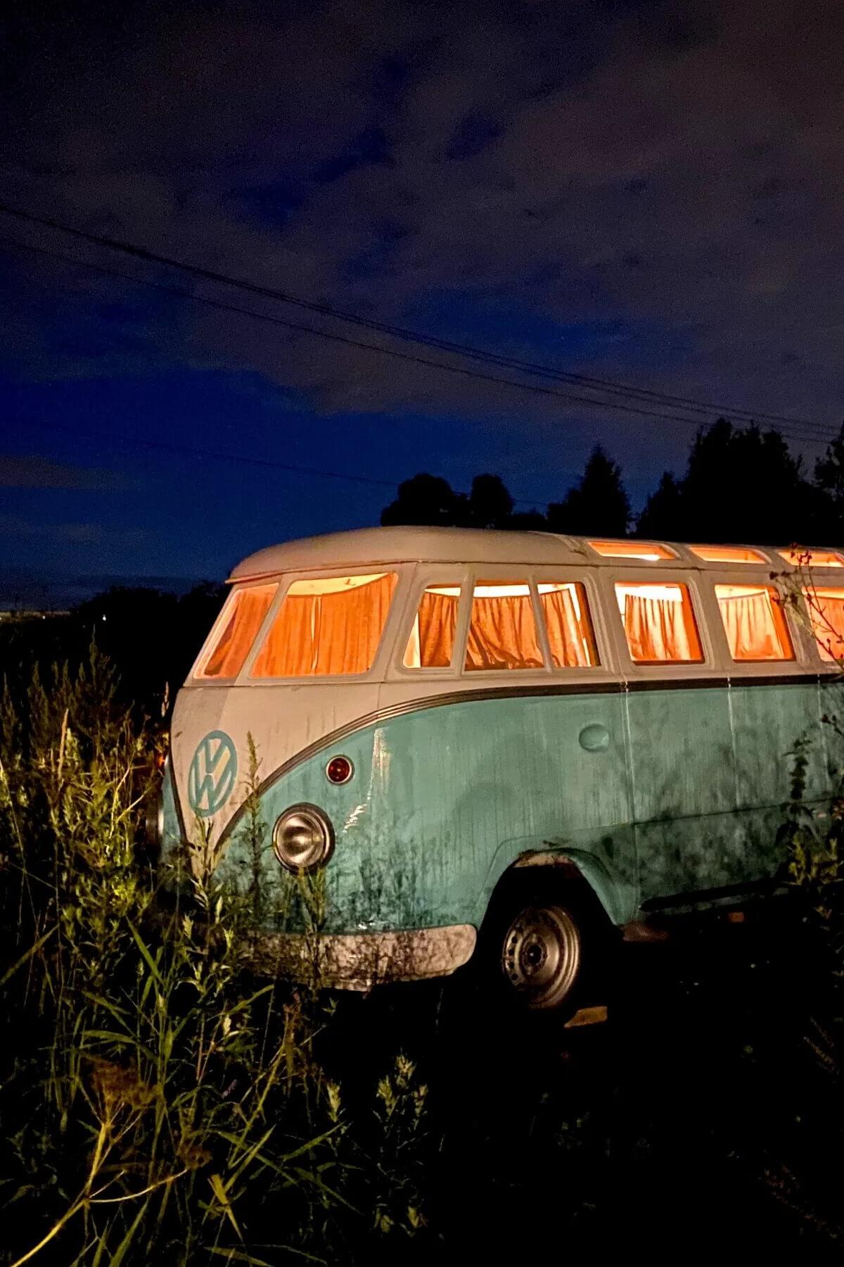 Ретро-автобус Volkswagen Transporter с подсветкой окон в сумерках.